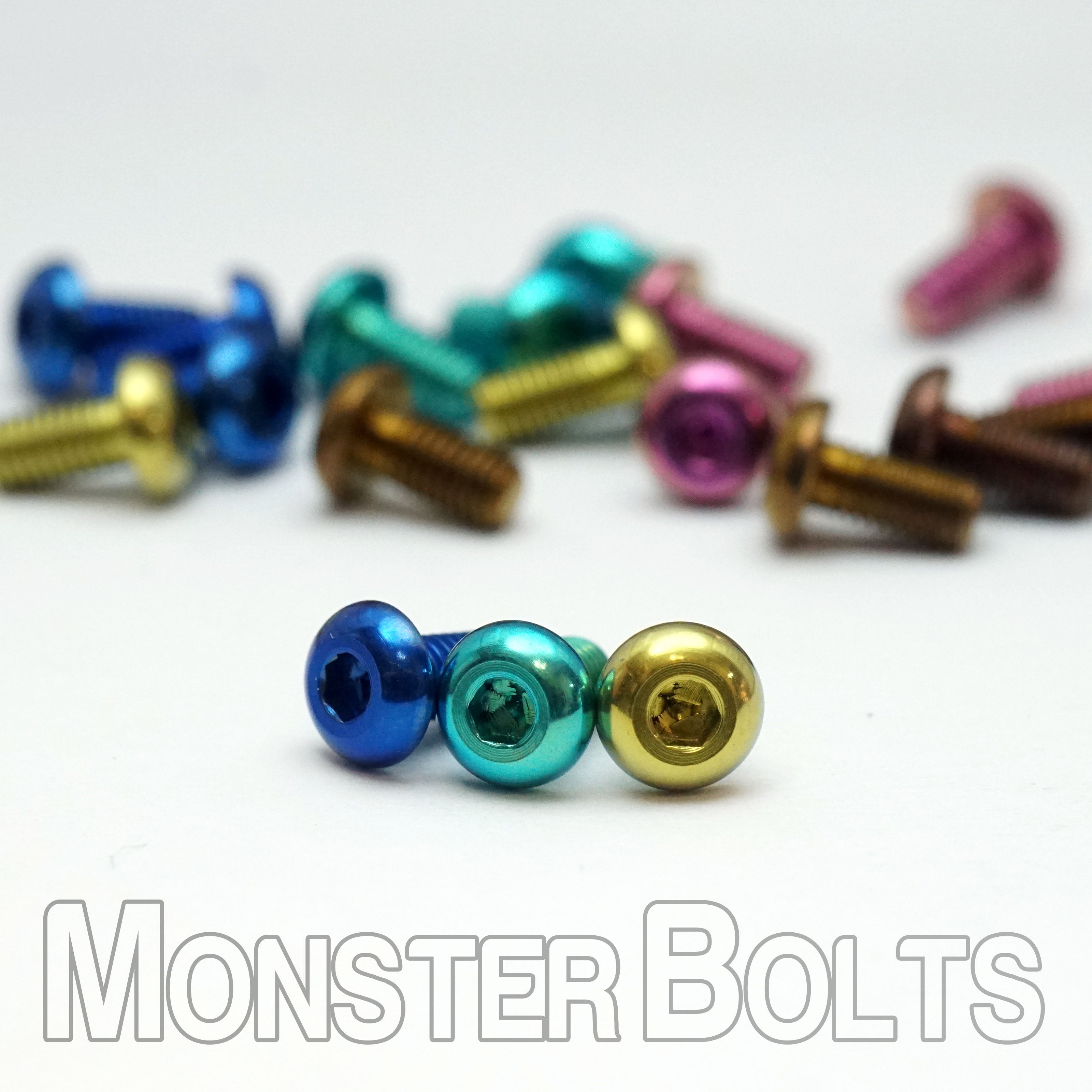 Button head anodized titanium screws in gold, green, and blue solid color finishes — precision hardware by Monster Bolts