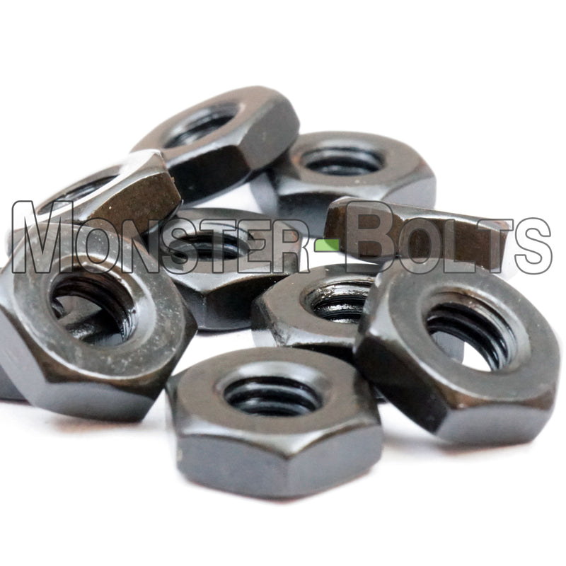 Assortment of black US hex nuts shown laying arranged randomly on white background.