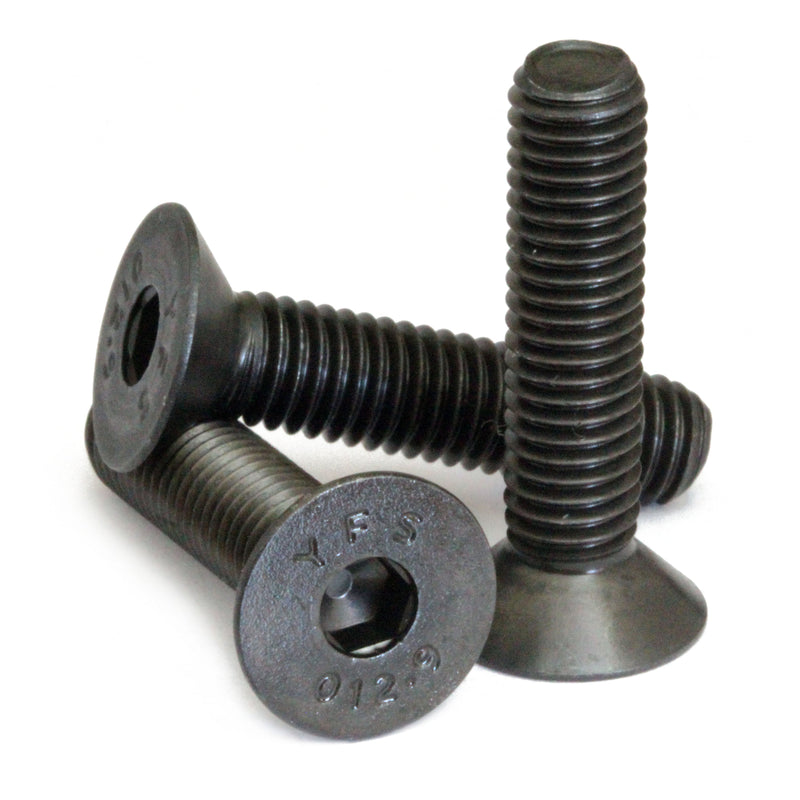 Countersunk Black SAE 1/4-28 Flat Head cap screws stacked to show different angles on white.