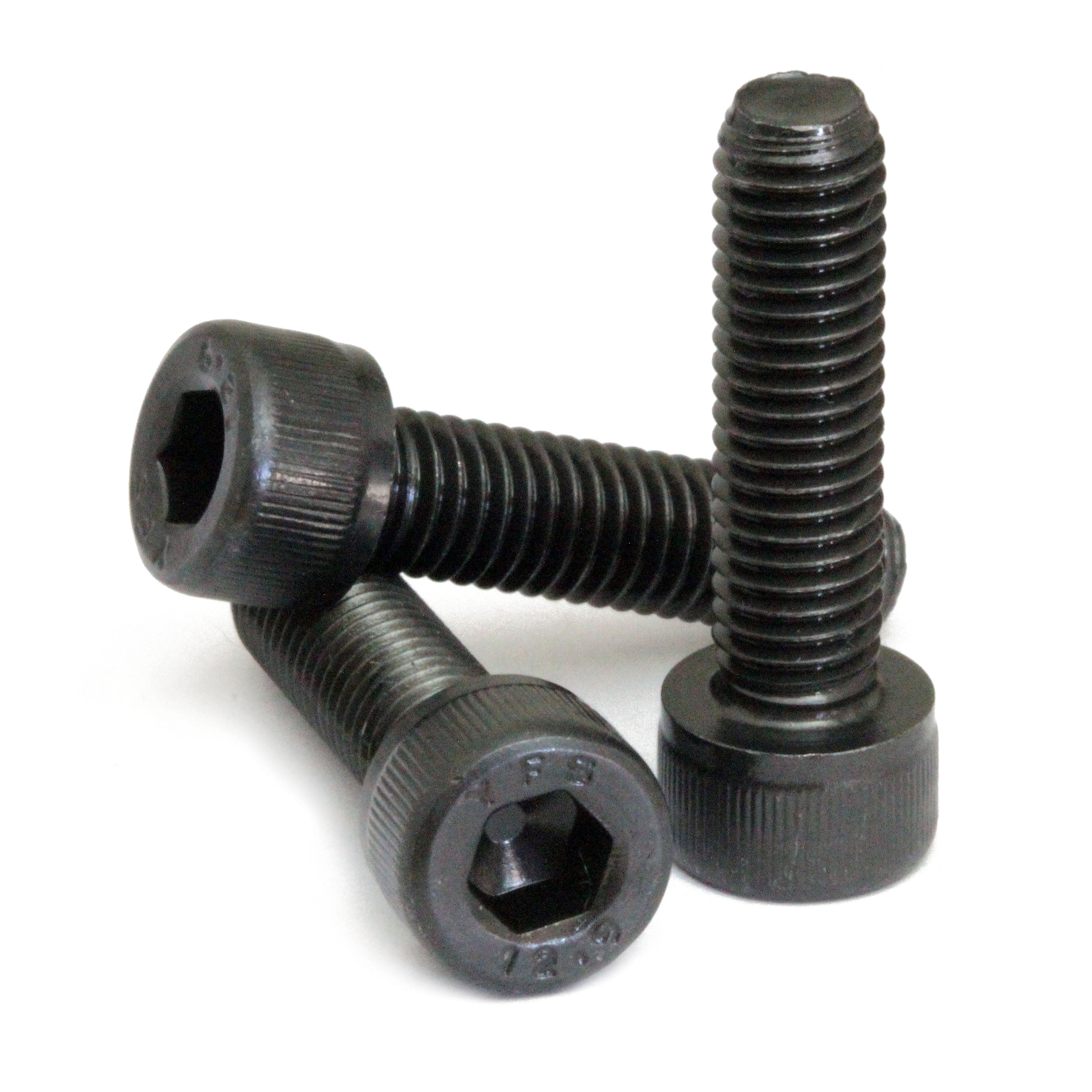 Black SAE #6-40 Socket Head cap screws stacked to show different angles on white.