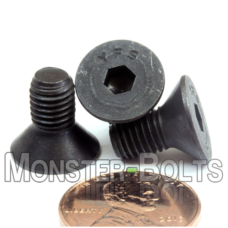 Countersunk Black 1/4-28 x 1/2" flat head socket screws, with US penny for size.