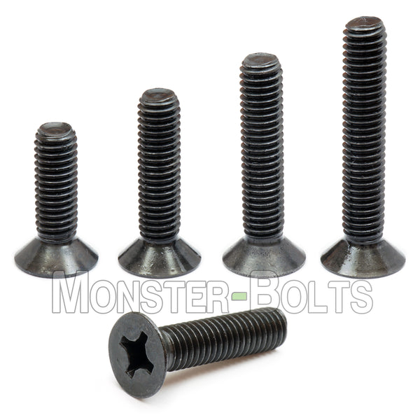 Black M3 Phillips flat head machine screws stacked to show different lengths with white background.