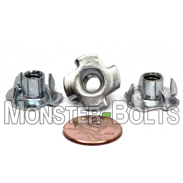 1/4-20 x 5/16" 4-Prong T-Nuts on a white background staged with a penny to show size.